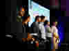 Speakers standing in front of a screen with B Lab's envision projected- a global economy that uses business as a force for good.