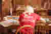 The back of a women wearing a red T shirt that says "using business as a force for good".