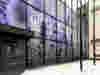 Large glass windows covered in graphics to communicate the company's Certified B Corporation status. The display shows a background of purple lavenders, alongside the Certified B Corp logo and the quote "Doing well by doing good".