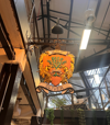 A decorative crest sign of the Jamie Oliver Group.