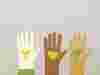 Three paper cutout hands with eco-friendly symbols, representing different forms of ownership, unity and sustainability.
