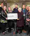 Zen Internet Community Charity standing with cheque at presentation